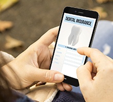 person looking at dental insurance information on their phone