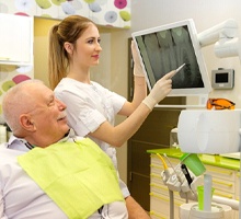 Dentist explaining how dental implants work in Salt Lake City