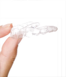 hand holding ClearCorrect clear teeth aligners
