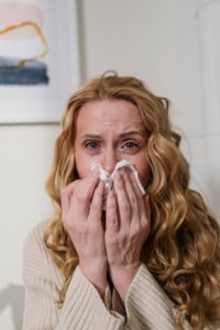 Woman with seasonal allergies and dental health concerns.