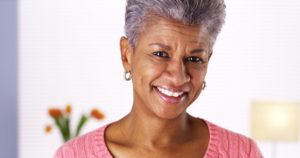 older woman smiling with dental implants