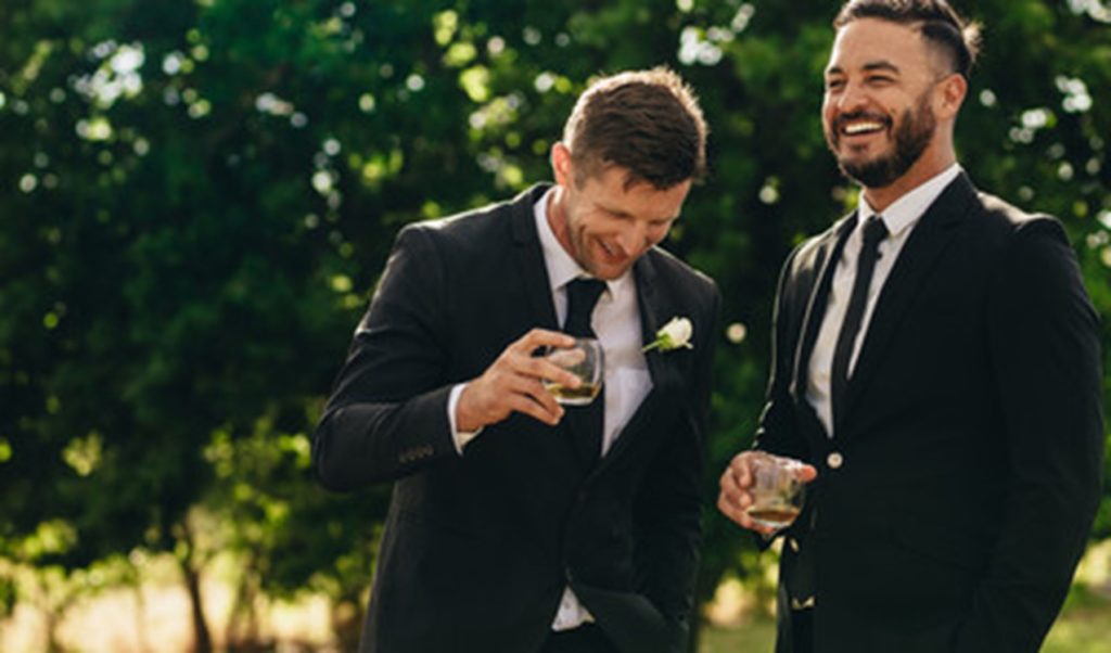 People smiling at a wedding.